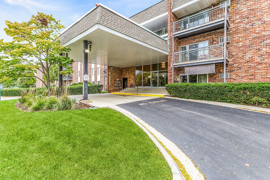 3913 Saratoga Avenue, Unit G306 Downers Grove, IL 60515 - Photo 2 of 18 a view of a building with a yard