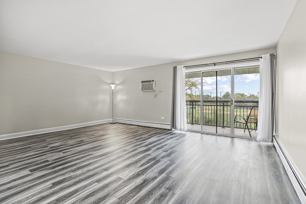 3913 Saratoga Avenue, Unit G306 Downers Grove, IL 60515 - Photo 5 of 18 wooden floor in an empty room with a window
