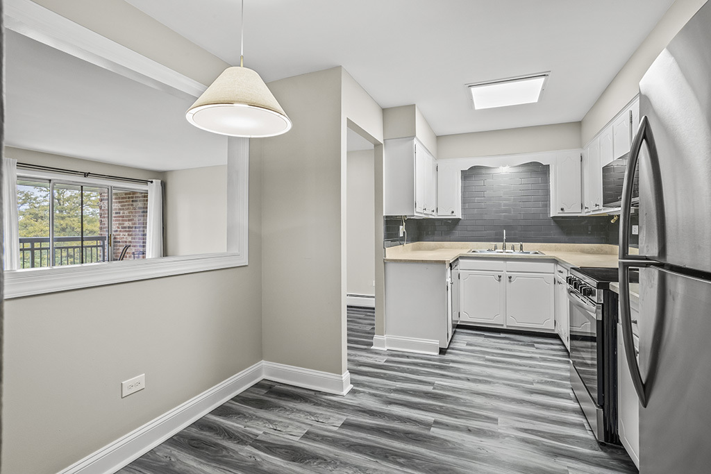 3913 Saratoga Avenue, Unit G306 Downers Grove, IL 60515 - Photo 7 of 18 a kitchen with a sink cabinets stainless steel appliances and a window