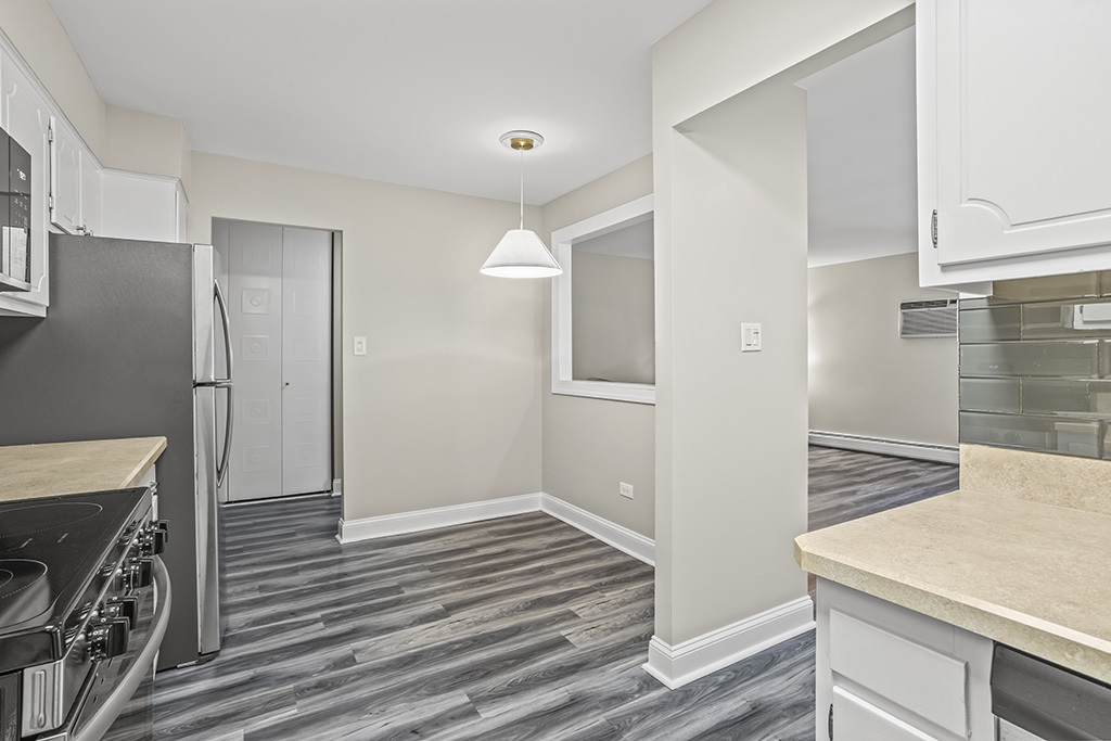 3913 Saratoga Avenue, Unit G306 Downers Grove, IL 60515 - Photo 8 of 18 a view of a hallway with entryway wooden floor and front door