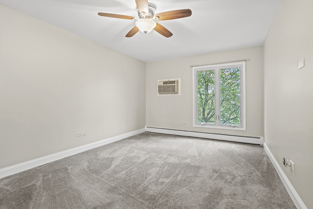 3913 Saratoga Avenue, Unit G306 Downers Grove, IL 60515 - Photo 10 of 18 an empty room with a window