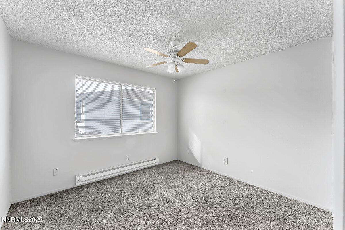 765 Jamaica Avenue, Unit 2 Reno, NV 89502 - Photo 14 of 23 an empty room with a window and a ceiling fan