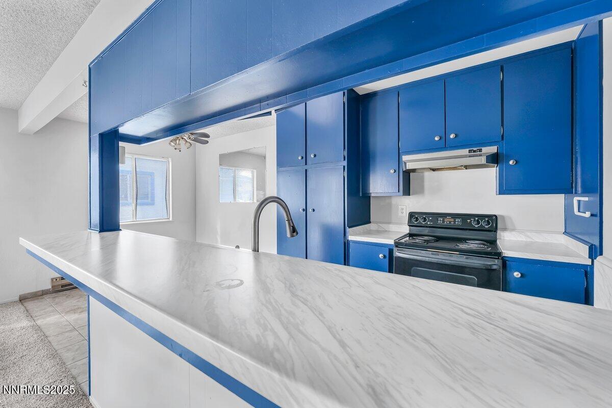 765 Jamaica Avenue, Unit 2 Reno, NV 89502 - Photo 6 of 23 a kitchen with stainless steel appliances granite countertop a stove a sink and a refrigerator