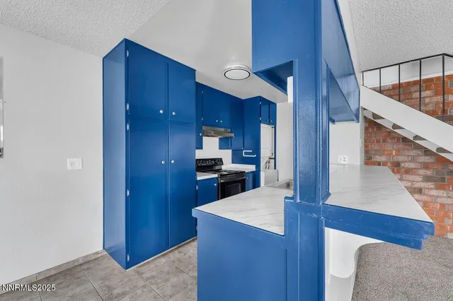 a kitchen with wooden cabinets and stainless steel appliances