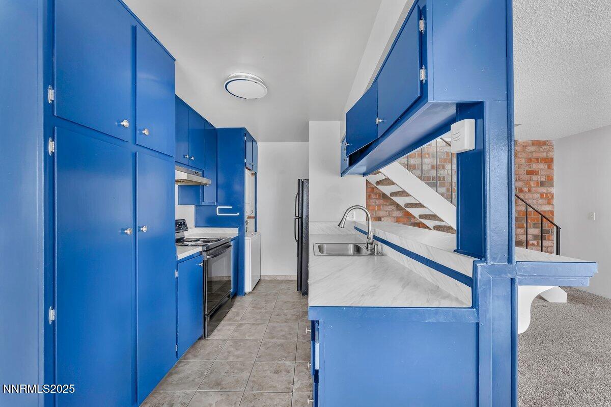 765 Jamaica Avenue, Unit 2 Reno, NV 89502 - Photo 8 of 23 a view of a kitchen from the hallway
