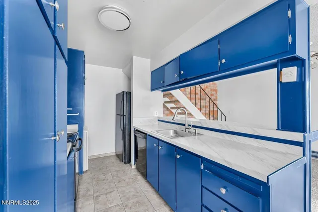 a kitchen with a refrigerator and a sink