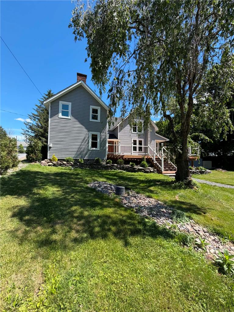 164 Sand Spring Road Cresco, PA 18326 - Photo 28 of 60 A classic grey-sided home featuring a spacious wooden deck and lush, well-maintained lawn.