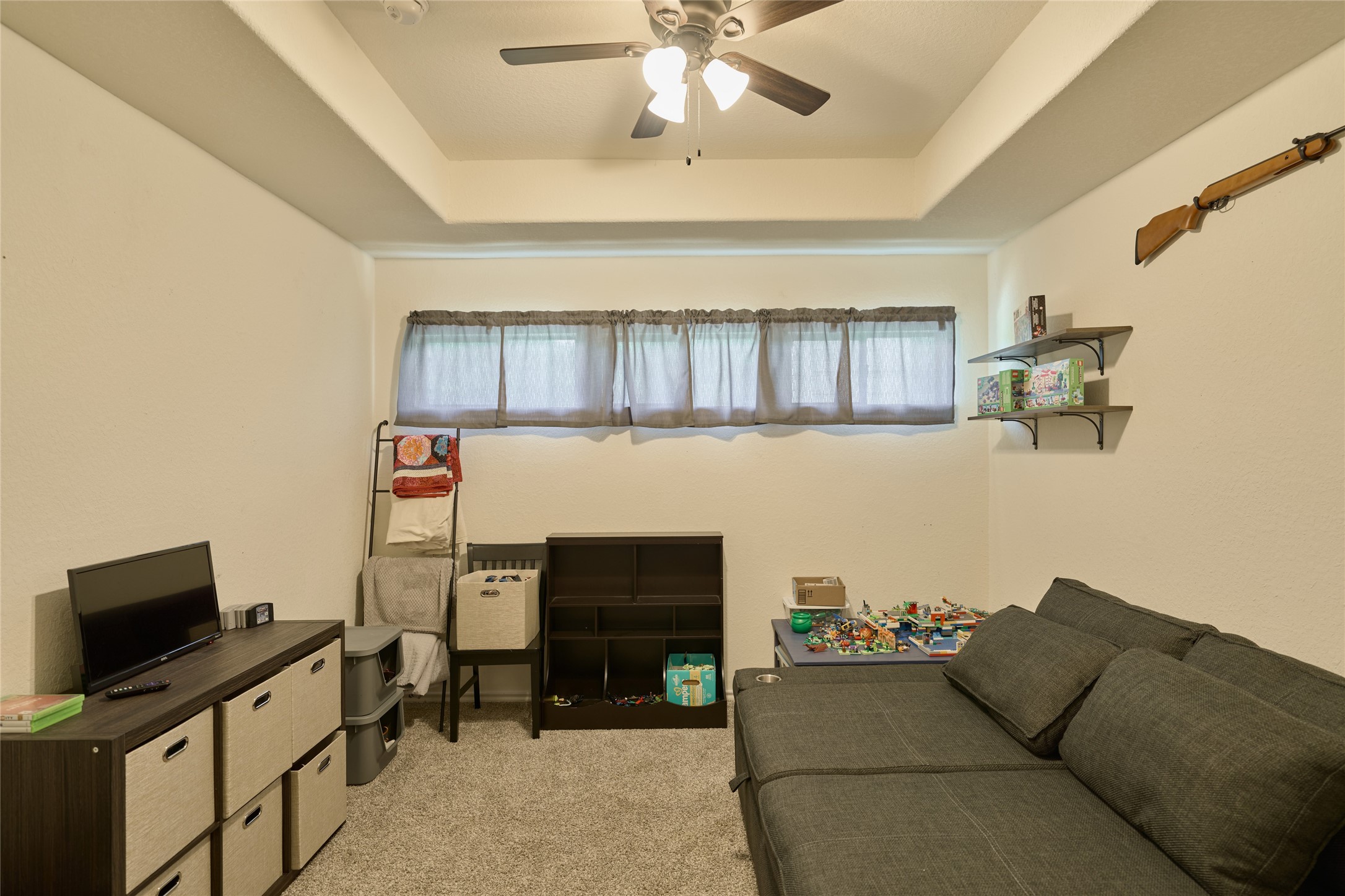 28322 Madelin Manor Lane Spring, TX 77386 - Photo 30 of 46 a living room with furniture and a flat screen tv