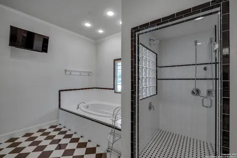 a bathroom with a tub and a shower
