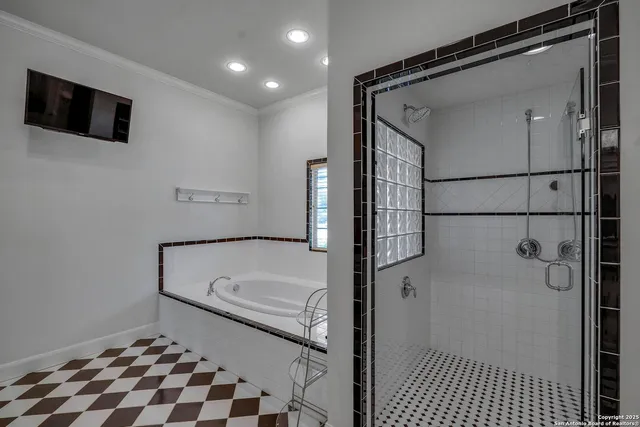 a bathroom with a tub and a shower