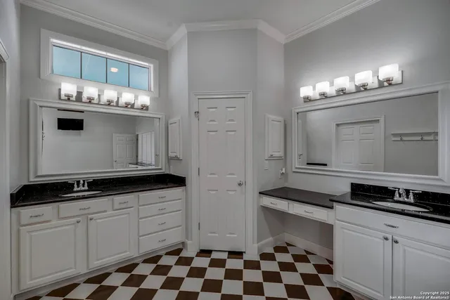 a kitchen with granite countertop white cabinets and stainless steel appliances