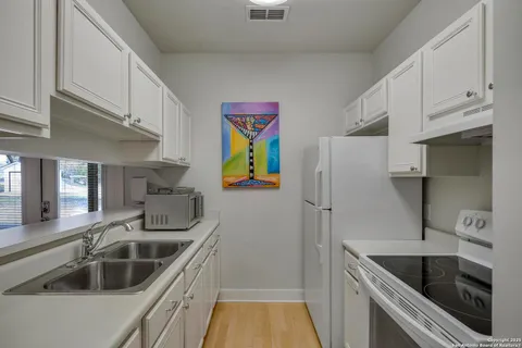 a kitchen that has a sink and a stove