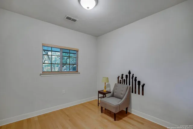 a view of a room with furniture and wooden floor