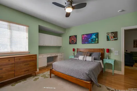 a bedroom with a bed dresser and window