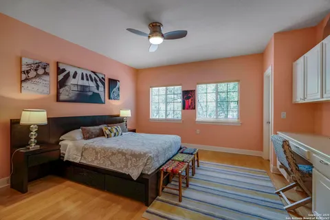 a bed room with a bed and a ceiling fan