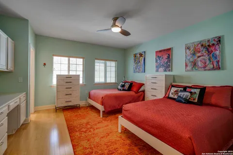 a bedroom with two beds and a chandelier