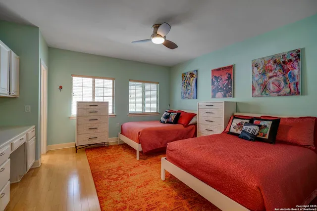 a bedroom with two beds and a chandelier