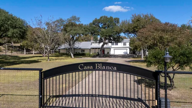 a view of swimming pool with outdoor seating and trees in the background