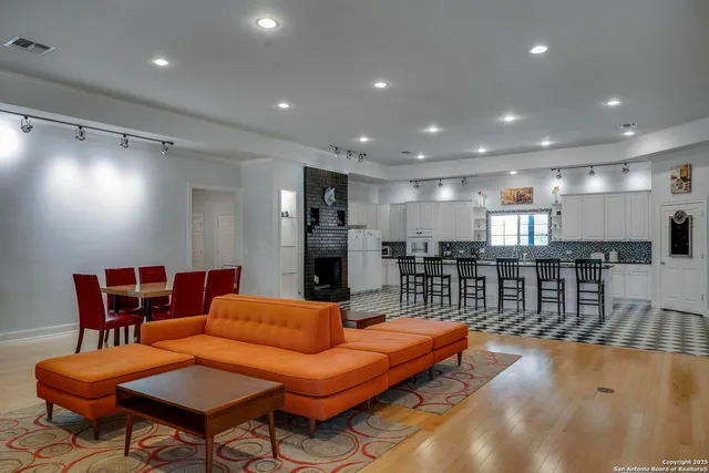 a living room with furniture a table and chairs