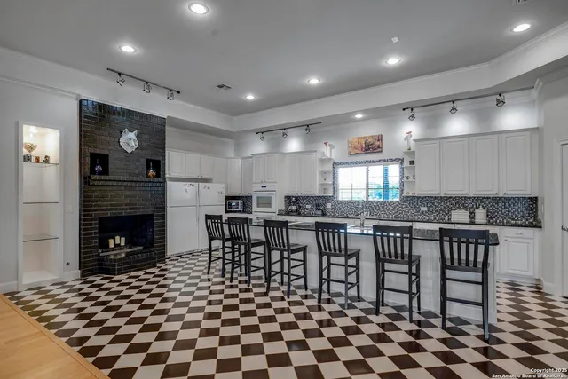 a kitchen with a dining table and chairs