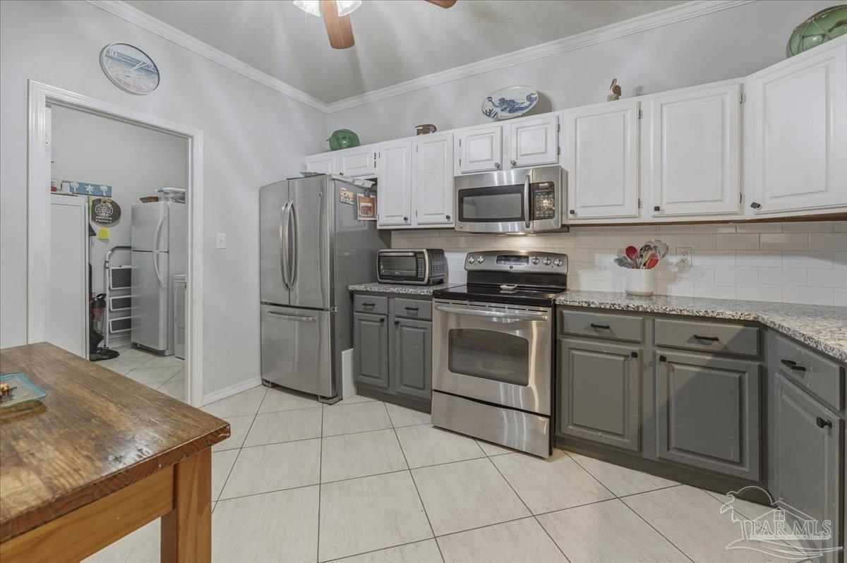 26063 Canal Road, Unit 3F Orange Beach, AL 36561 - Photo 30 of 72 a kitchen with stainless steel appliances granite countertop a sink stove and refrigerator