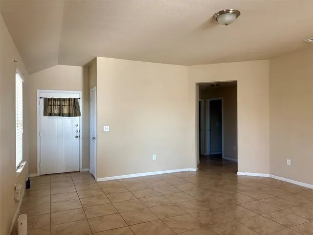 a view of hallway with a window and chandelier