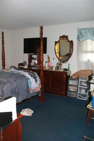 a bedroom with bed and window