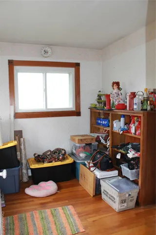 a room with wooden floor and furniture