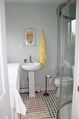 a bathroom with sink toilet and shower
