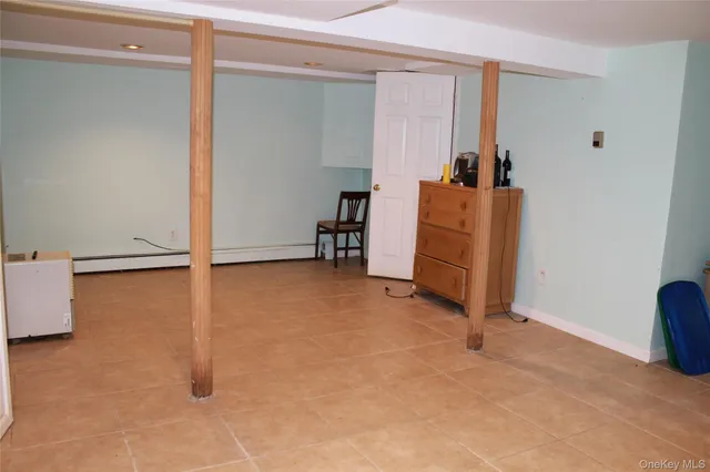 a view of a dining room with furniture and a window