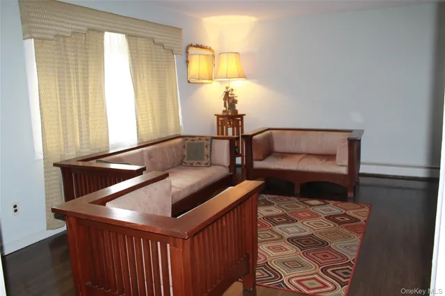 a living room with furniture and a lamp