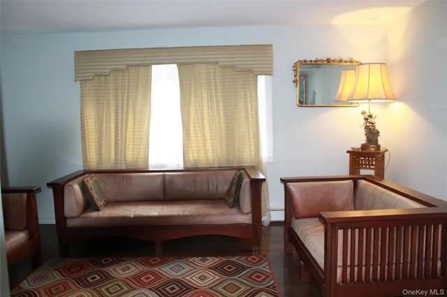 a dining room with wooden floor a chandelier a wooden table and chairs