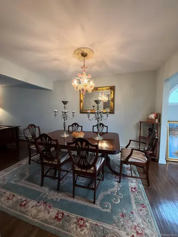 a view of a room with wooden floor and furniture