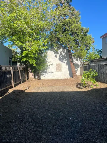 a view of yard with green space and trees in the background