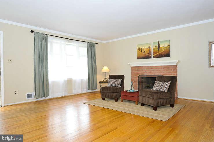 5613 Rathbone Place Springfield, VA 22151 - Photo 2 of 22 a living room with furniture and a fireplace