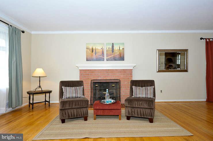 5613 Rathbone Place Springfield, VA 22151 - Photo 4 of 22 a living room with furniture and a fireplace