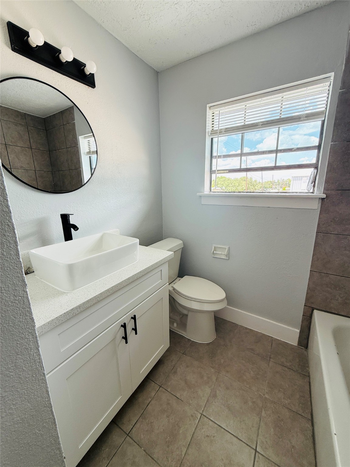 1125 Ann, Unit 4 Pasadena, TX 77506 - Photo 5 of 6 a bathroom with a toilet a sink and mirror