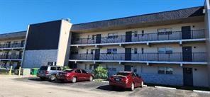 8020 North Colony Circle, Unit 110 Tamarac, FL 33321 - Photo 2 of 11 a front view of a building with glass windows