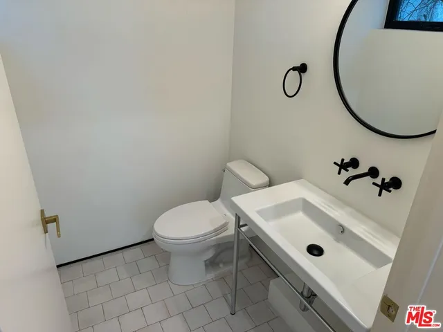 walk in closet with wooden floor