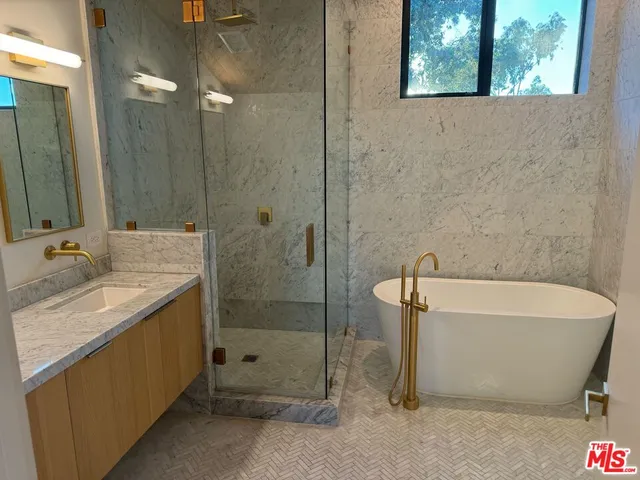 a bathroom with a double vanity sink mirror and shower