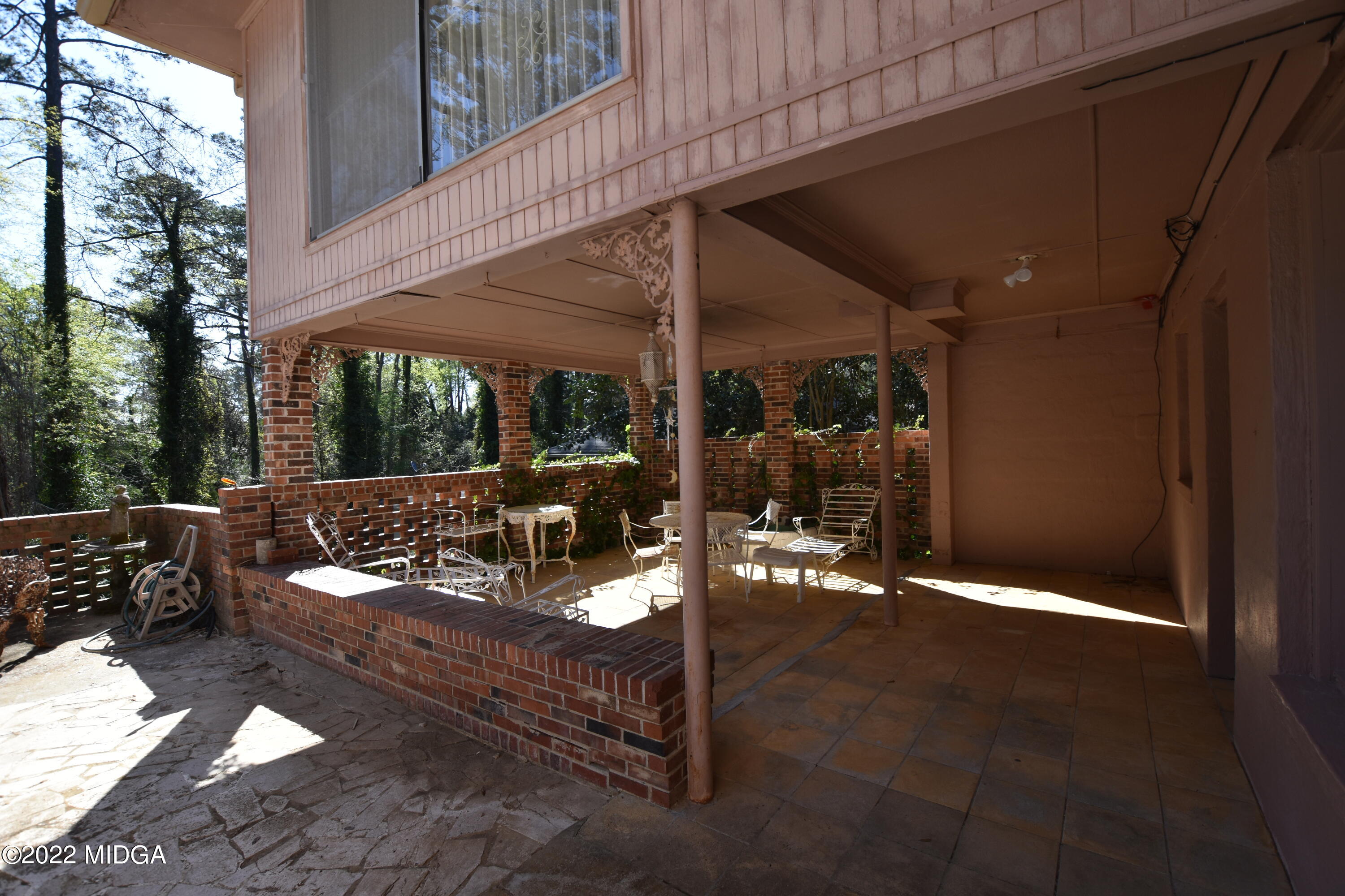 2159 General Winship Drive Macon, GA 31204 - Photo 9 of 31 a view of a patio with table and chairs potted plants with wooden fence