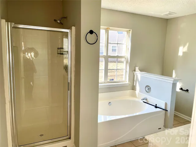 a bathroom with a bathtub and shower