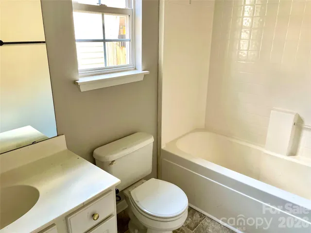 a bathroom with a sink a toilet and bathtub