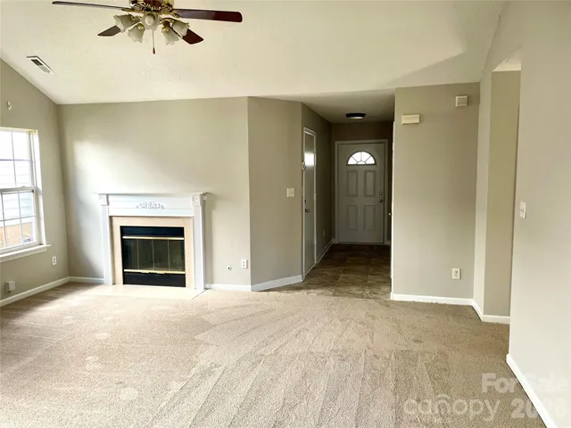 a view of an empty room with a fireplace