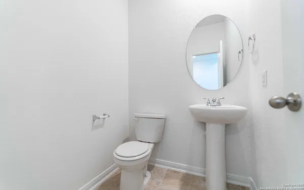 a bathroom with a sink a mirror and toilet