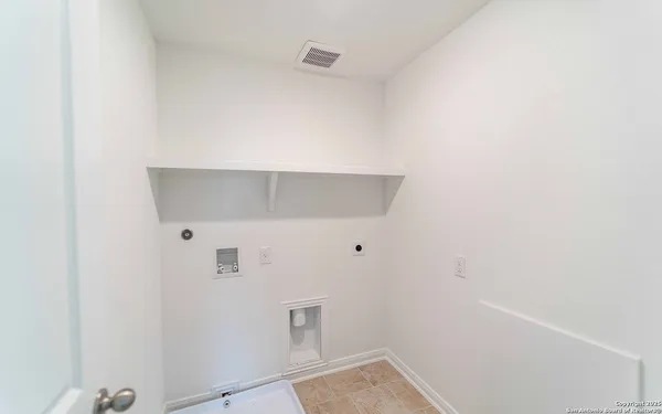 a view of walk in closet with clothes