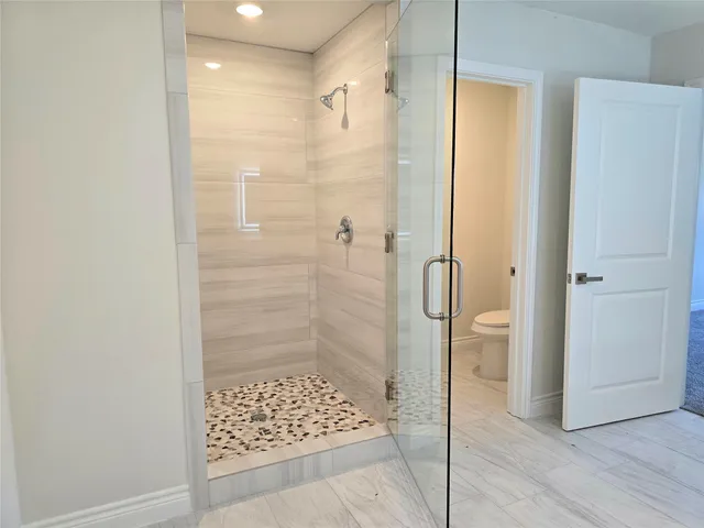 a bathroom with a shower and a sink