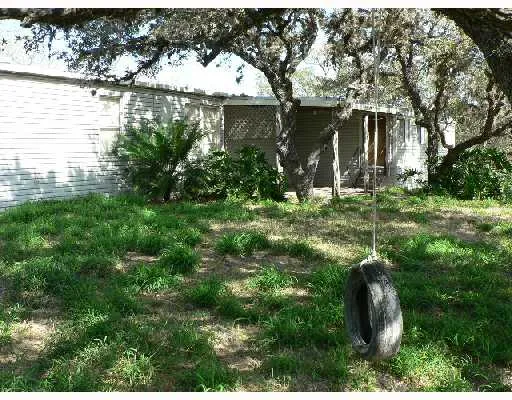 a backyard of a house with lots of green space and lake view