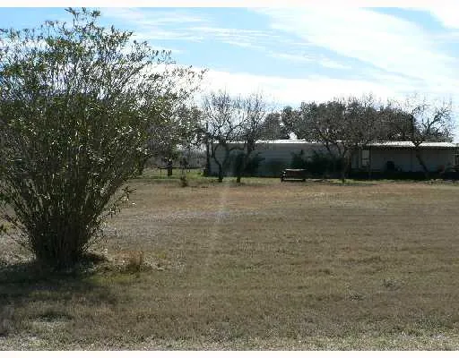 a view of a field with an trees