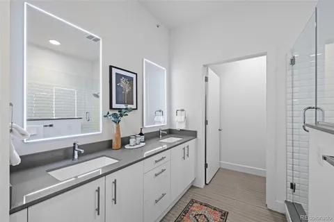 a bathroom with a granite countertop sink mirror and double